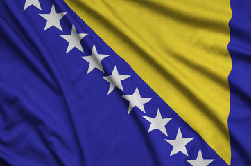 Bosnia and Herzegovina flag  is depicted on a sports cloth fabric with many folds. Sport team banner