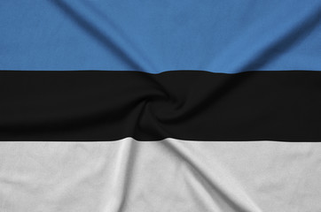 Estonia flag  is depicted on a sports cloth fabric with many folds. Sport team banner