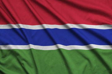 Gambia flag  is depicted on a sports cloth fabric with many folds. Sport team banner
