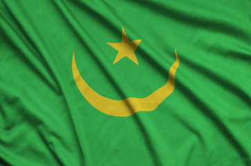 Mauritania flag  is depicted on a sports cloth fabric with many folds. Sport team banner