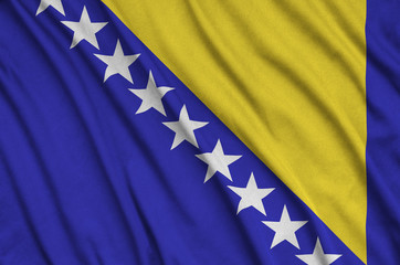 Bosnia and Herzegovina flag  is depicted on a sports cloth fabric with many folds. Sport team banner