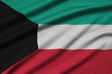 Kuwait flag  is depicted on a sports cloth fabric with many folds. Sport team banner