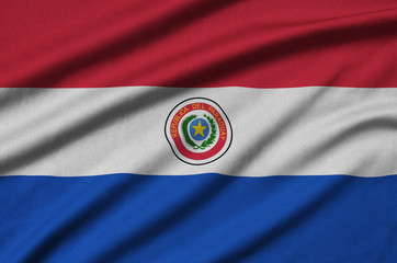 Paraguay flag  is depicted on a sports cloth fabric with many folds. Sport team banner