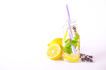 Ice cold lavander lemonade, lemon, straw. Two classic virgin mojito drinks, non alcoholic cocktail with ice in two vintage hipster bottles, isolated white background. Copy space, top view close up.