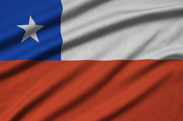 Chile flag is depicted on a sports cloth fabric with many folds. Sport team banner