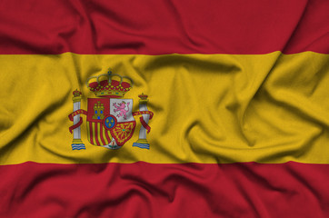 Spain flag  is depicted on a sports cloth fabric with many folds. Sport team banner