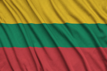 Lithuania flag  is depicted on a sports cloth fabric with many folds. Sport team banner
