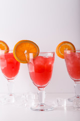 three glasses of lemonade with orange