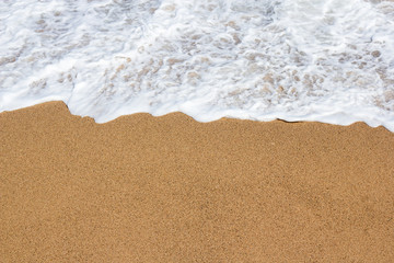 summer background - close up of sand and sea water on the beach