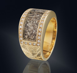 Golden ring with gemstone isolated on black background