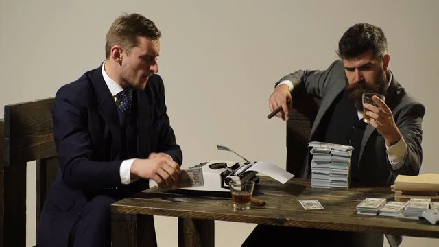 Businessmens are counting money, drinking whiskey and smoking cigars. Shadow economy.
