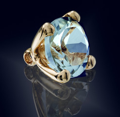 topaz swiss gem stone in golden setting isolated