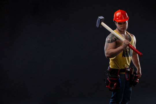 Brutal Muscular Worker Man With A Hammer