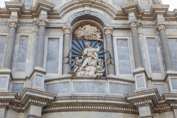Fototapeta na wymiar Fragment of façade of Catania Cathedral (Italian: Duomo di Sant'Agata), dedicated to Saint Agatha.It is an example of Sicilian Baroque architecture.