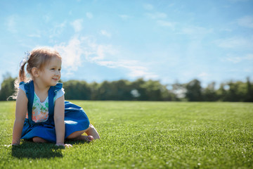 Fototapeta premium happy girl portrait on the grass on a sunny day