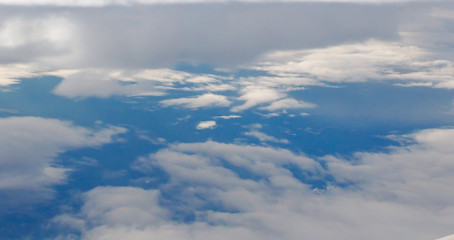 Sky and Clouds View from above through a window airplane at sunrise