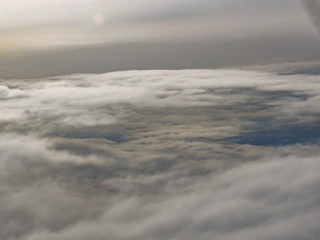 Sky and Clouds View from above through a window airplane at sunrise