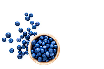 Fresh recently picked blueberries in bowl on white background top view copy space