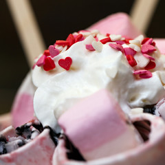 Fruit roll ice cream is decorated with caramel in the shape of heart.