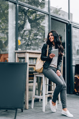 Young pretty spanish woman in cafe in city centre