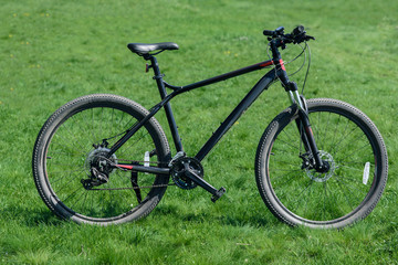 Fototapeta na wymiar Closeup of sportive bicycle on green grass meadow background