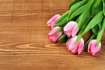 tulips on a wooden surface