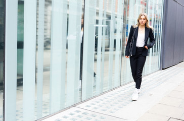 Teenage girl walking down a street with a suit on