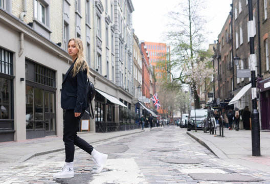 Teenage Girl Crossing A Zebra Crossing In London Shopping