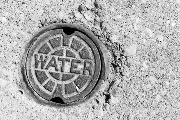 Water lid in sidewalk