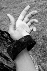 Hand in shackle and chains, black and white