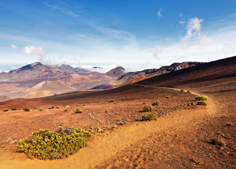 Wide volcanic landscape with lava fields in different colors, wide view, ocher shades, reds, trail,...