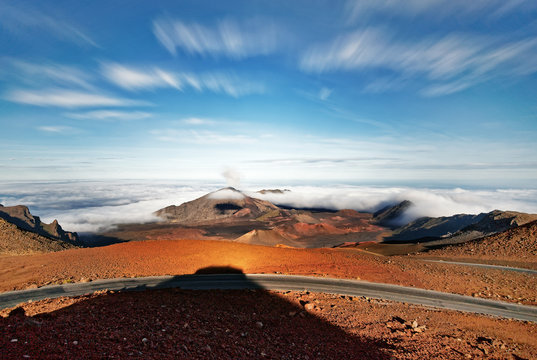 Wide volcanic landscape with lava fields in different colors, wide view, cloud movement and long shadows in evening light - Location: Hawaii, Island Maui, volcano "Haleakala" (Haleakalā)
