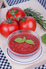 A bowl of mashed tomato with tomatoes