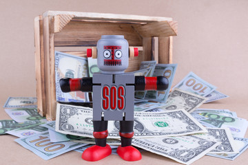 SOS word written on standing robot with wooden money crate