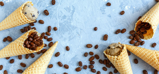Waffle cones with coffee ice cream and beans.