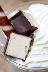 Decoration of a milkshake with confectionery. Cold sweet dessert.
