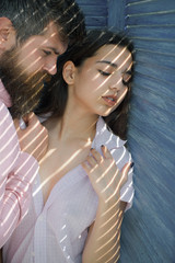 Enjoy closeness. Taking off her dress. Bearded man hug arabian woman. Passion and desire. Couple in love