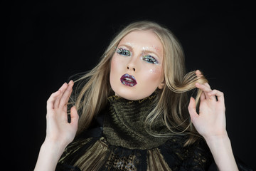 Beautiful girl in studio on a black background. Cosmetics