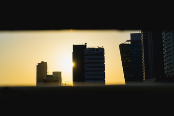 Sunset through a viewpoint with the Tel Aviv skyline