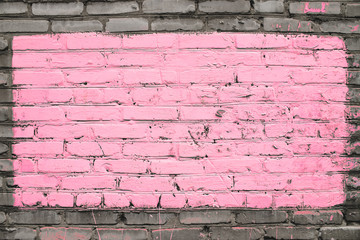 Old realistic dirty brick wall made of pink brick. Uneven brickwork. Center of wall is painted pink. Big rectangle for mock up in center of shot close-up.