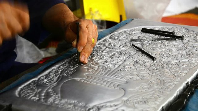 The art and pattern of carving silverware. Demonstration of the silverware of the Northerners, Thailand. Thai handicraft style.