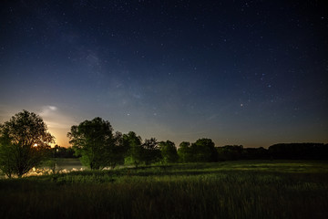 Stars of the Milky Way in the night sky. A view of the starry space background sunset illuminated the horizon.