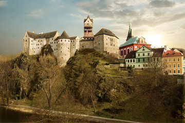 Amazing landmark in Czech Republic, near Karlovy Vary Loket middleaged castle with sunset and blue sky in spring.