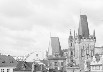 View of Charles bridge (Karluv Most) Lesser Town Bridge Tower and the tower of the Judith Bridge in black and white colors. 