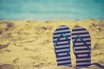 Flip flops on sand beach