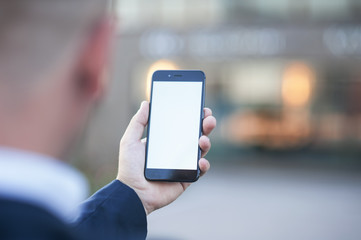 Touch screen of a mobile phone, in the hand of a businessman. Photo for Mock Up