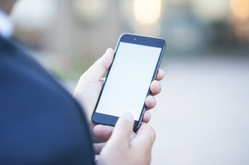 Touch screen of a mobile phone, in the hand of a businessman. Photo for Mock Up