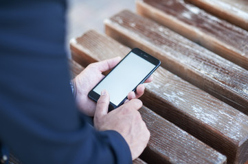Touch screen of a mobile phone, in the hand of a businessman. Photo for Mock Up