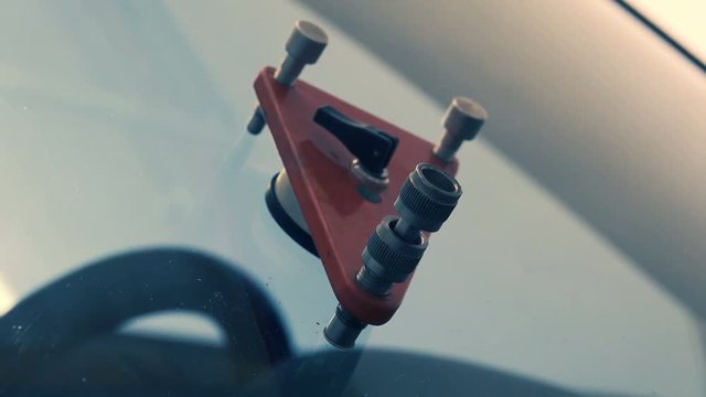 Works on repair of windshield. Closeup shot
