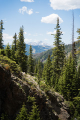 Landscape view of Mount of the Holy Cross seen through a forest near Vail, Colorado. 